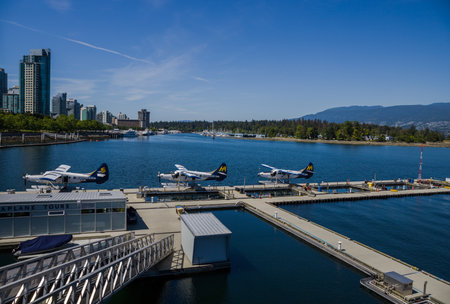 Vancouver, British Colambia - 16.08.2021 - Downtown water plane airport. Three hydroplanes staying in water.のeditorial素材