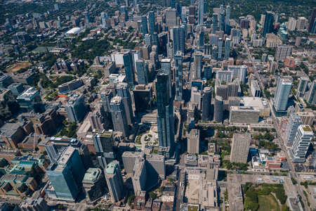 Aerial city view with crossroads and skyscrapers, houses, buildings, parks and parking lots. Helicopter shotの写真素材