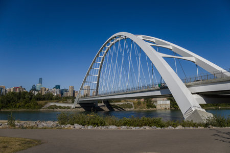 Modern arc bridge over the river, day traffic, summer time. modern architecture, panorama of the...