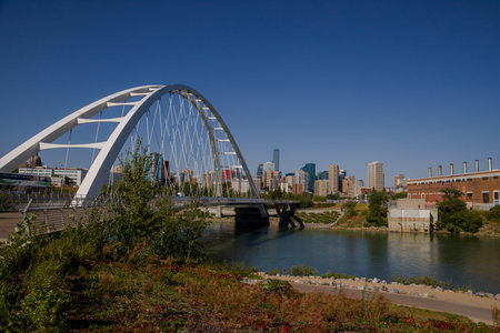 Modern arc bridge over the river, day traffic, summer time. modern architecture, panorama of the city Edmonton, Alberta, Canadaのeditorial素材