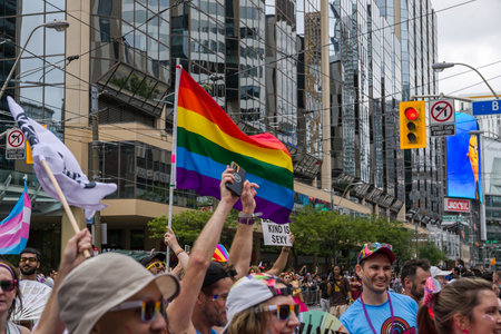 People participating in the World Pride Parade in Toronto. People with huge rainbow LGBTQ+ flag and banners move together in a column, have fun, dance
TORONTO, ONTARIO, CANADA 2024のeditorial素材