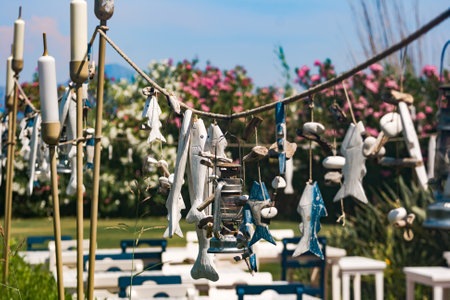 Outdoor patio decoration - nautical theme in the garden, wooden fish-shaped pendant hanging on a rope outside.
unknown authorの写真素材