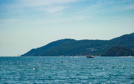 Seascape with a boat on the sea and mountains in the backgroundの写真素材