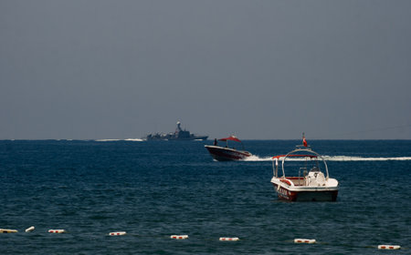 Sea navigation - a ship and two tourist boats sailing in different directions. Sea vacation -...