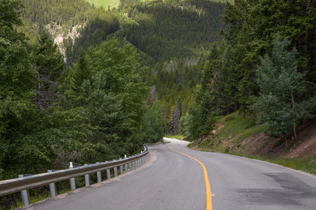 Scenic empty winding road along the forest in Banff National Park, Alberta, Canada in the morning. One of the most beautiful viewpoints. Scenic country road in the forest.の写真素材
