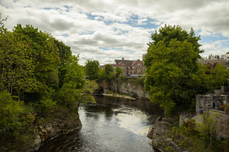 Fergus - town in Ontario on the Grand River, popular tourist town with beautiful old stone houses, a waterfall, and ancient bridges. A tourist magnet. Summer sunny dayの写真素材