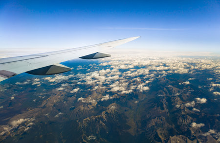 Aerial view of the clouds and blue sky from airplane window.の写真素材