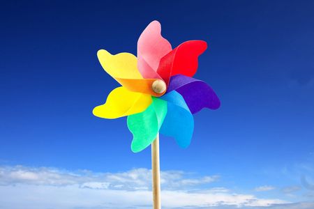 close up of a toy windmill outside at the beach