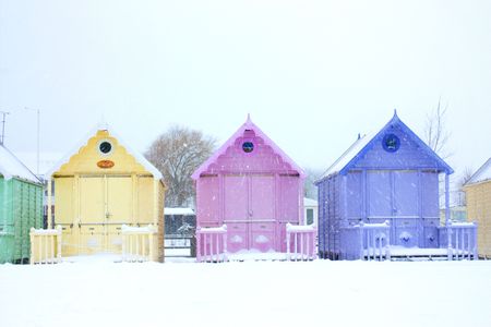beach huts close up in a snowstorm in west mersea, essexの写真素材