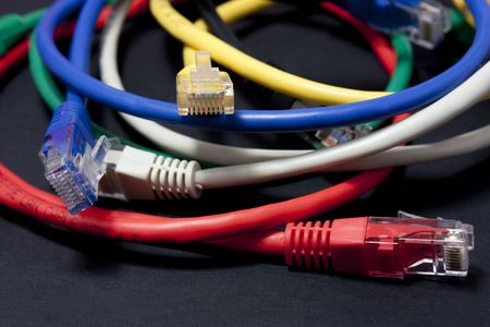 Set of brightly coloured network cables on white background