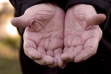 close up macro shot of an 80 year olds hands with wrinkles and wearの写真素材
