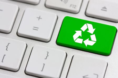 green recycle button on a modern silver keyboardの写真素材
