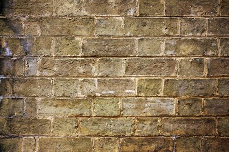 historic old worn brickwork with a tellow tingeの写真素材