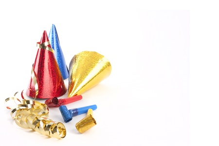 Party hats, blower and streamers isolated on whiteの写真素材