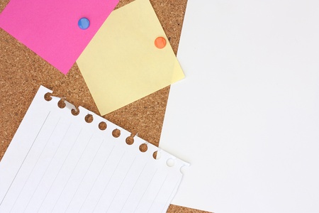 pink, yellow and white notes pinned to a pinboardの写真素材