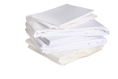 pile or stack of cotton white bed sheets