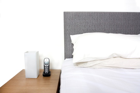 Modern bedroom close up of pillows, headboard and tableの写真素材