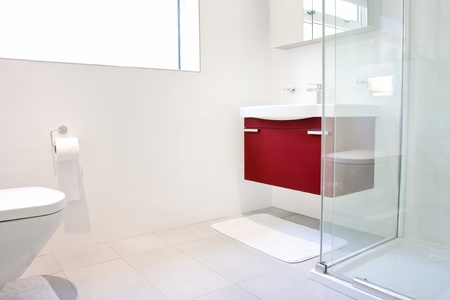Modern bathroom with wall hung toilet and sink unitの写真素材