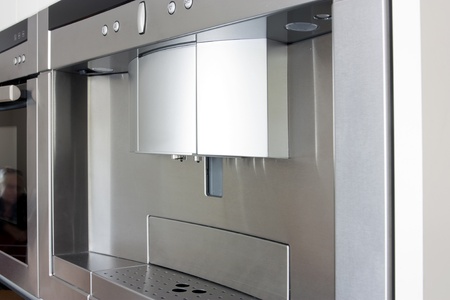 coffee maker in stainless steel built into the kitchen unitsの写真素材