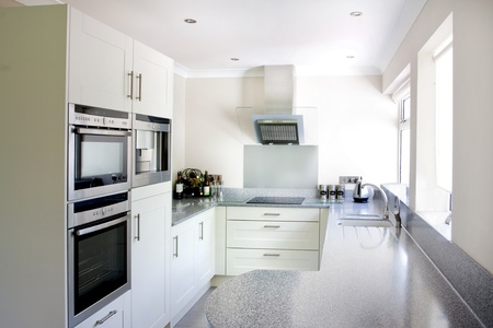 new white modern kitchen and stainless steel appliancesの写真素材