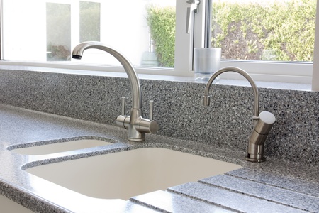 Modern kitchen granite worktop and ceramic sink with mixer tapの写真素材