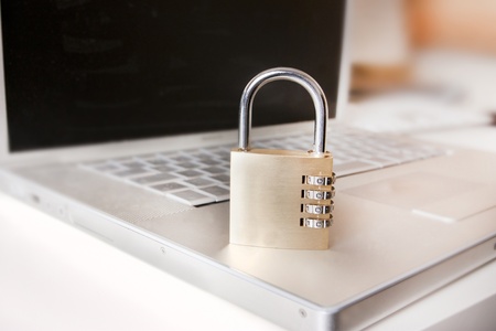laptop and padlock as a metaphor for secure systems and computingの写真素材