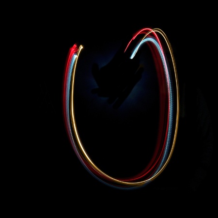 Letter U on a black background made with light painting torchesの写真素材