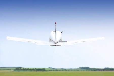 small lightairplane taking off on summers day