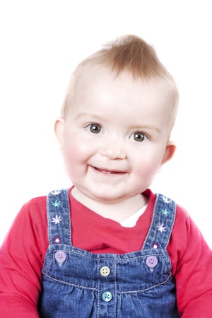1 year old cute blonde girl looking at cameras and smiling isolated on a white backgroundの写真素材