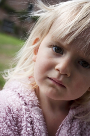 Portrait close up of girl frowning thinking or not happyの写真素材