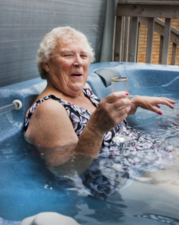 woman pensioner over the age of 70 in hot tubの写真素材