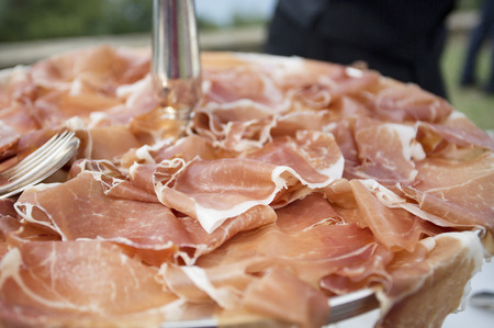 close up focus of lots of slices of parma hamの写真素材