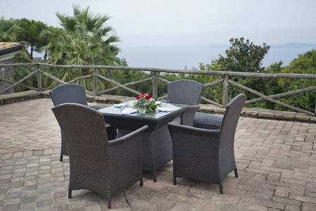 Overlooking the italian ocean with roses on the tableの写真素材