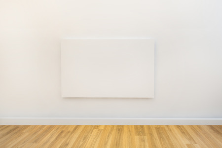 empty artwork ready for design to be added on white wallの写真素材