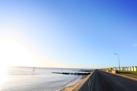 early morning sunrise showing beach and beach huts at harwich, ukの写真素材