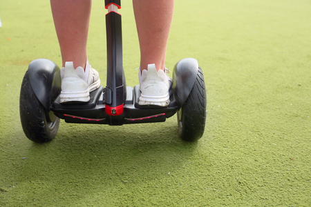 children playing on a segway on astroturf outside, safe, beginners class
