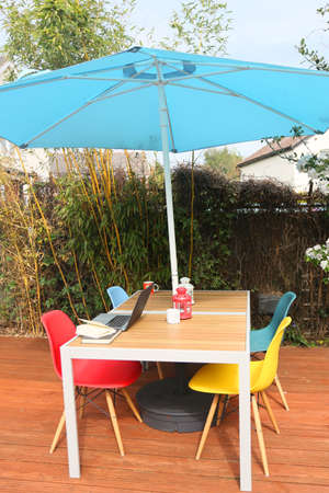 working from home on a modern teak deck and tableの写真素材