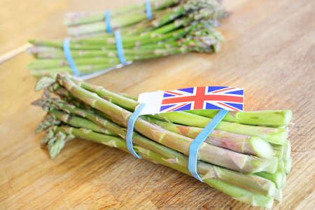In season asparagus with a british union jack flag on a wooden tableの写真素材