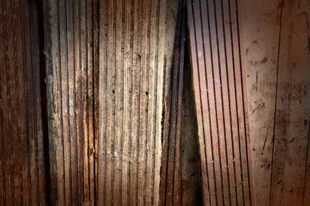 rustic old battered oak or teack decking or wood boards for use as a backgroundの写真素材