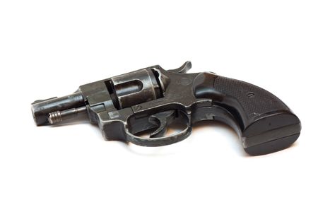 Old dirty revolver gun on whiteの写真素材