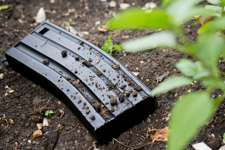 Airsoft gun magazine on the groundの写真素材