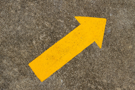 Arrow traffic sign on the roadの写真素材
