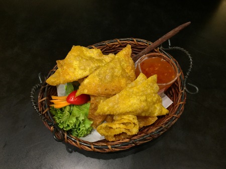 crispy fried wanton sheet with sauce on the tableの写真素材