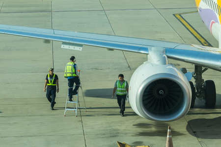 BANGKOK, THAILAND - DEC 29 2016. airport officer and truck Refueling of the aircraft at Don Mueang international airport (DMK)のeditorial素材
