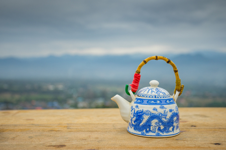 Chinese style teapot with mountain background viewの写真素材