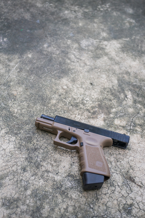 BANGKOK, THAILAND - 29 OCT 2017: Glock 19 two tone airsoft 6 mm bullet ball pistol gun on the floorのeditorial素材