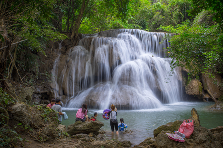 KANCHANABURI THAILAND 20 JAN 2018: Many people swimming around Huaymaekamin Waterfall with tree in kanchanaburi province Thailandのeditorial素材