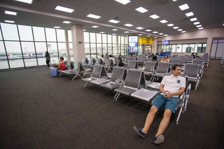BANGKOK THAILAND 2 FEB 2018: Many people sitting in the terminal waiting for flight at Don Mueang...