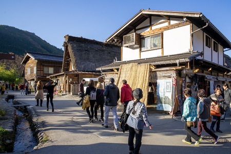Shirakawa Japan - 12 Nov 2019: Many people walking around traditional Gusso farmhouse at Shirakawa go village in autumn, Japan.のeditorial素材