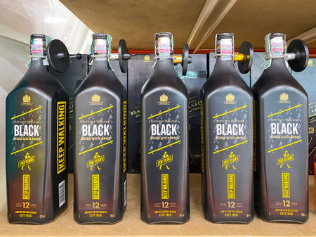 Bangkok Thailand - 28 May 2022: Many bottles of Johnnie Walker black Scotch whisky on shelf for sale in the Big C supermarket in Bangkok Thailandのeditorial素材